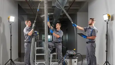 Technician cleaning home air ducts in Knoxville TN for Five Star Cooling HVAC service