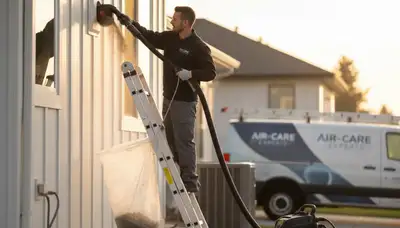 Technician performing professional dryer vent cleaning service in Knoxville, TN home